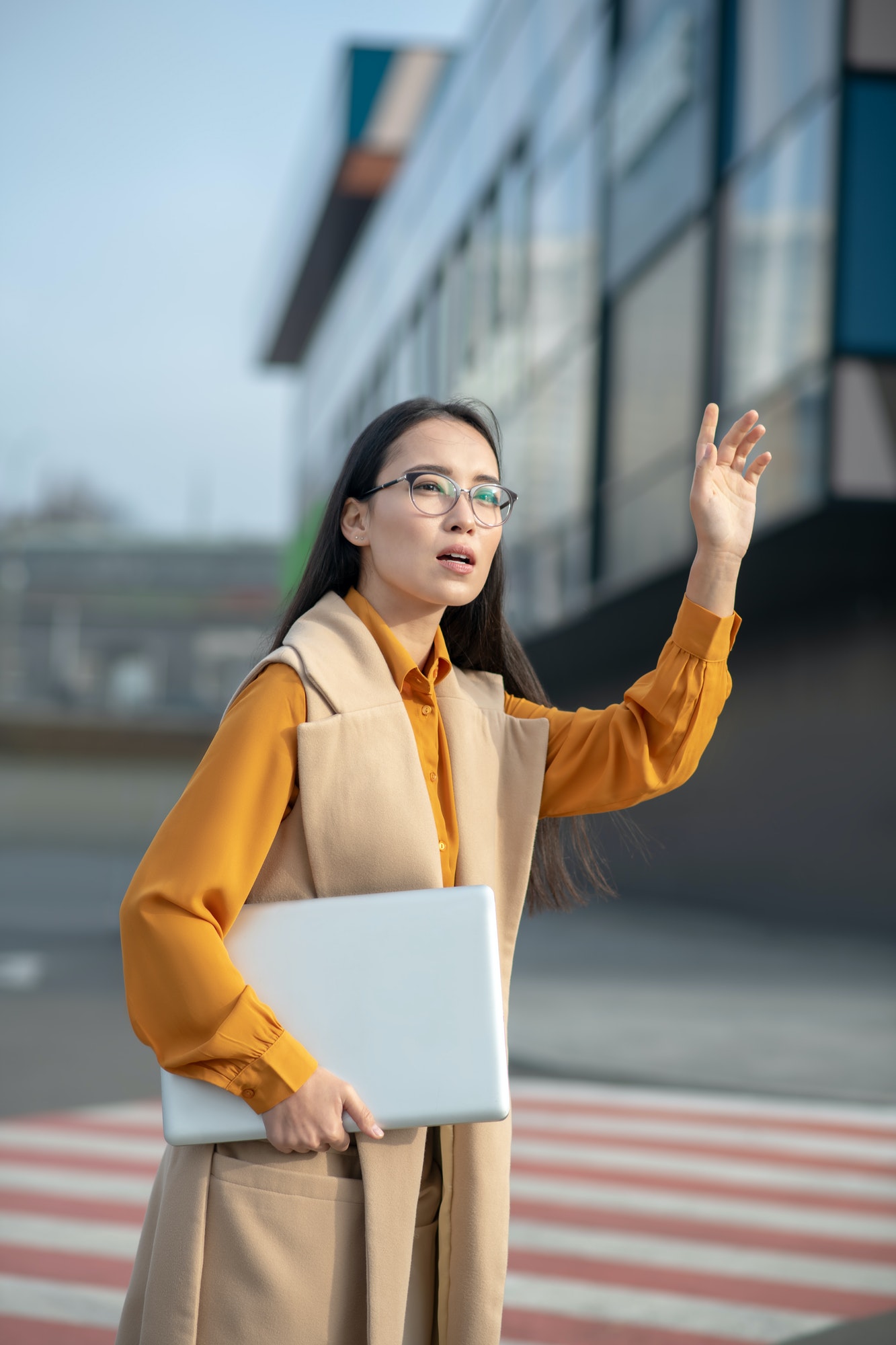 young-asian-pretty-woman-waving-her-hand-on-the-road.jpg